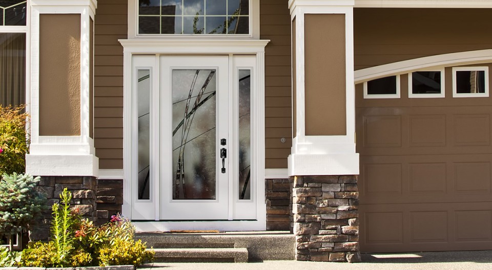 White fibreglass entry door with contemporary-styled decorative glass on a suburban home