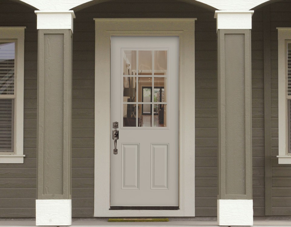 White steel entry door on the front of a home with taupe siding