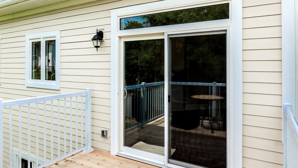 Challenger patio doors on the back of a home leading to a wooden deck