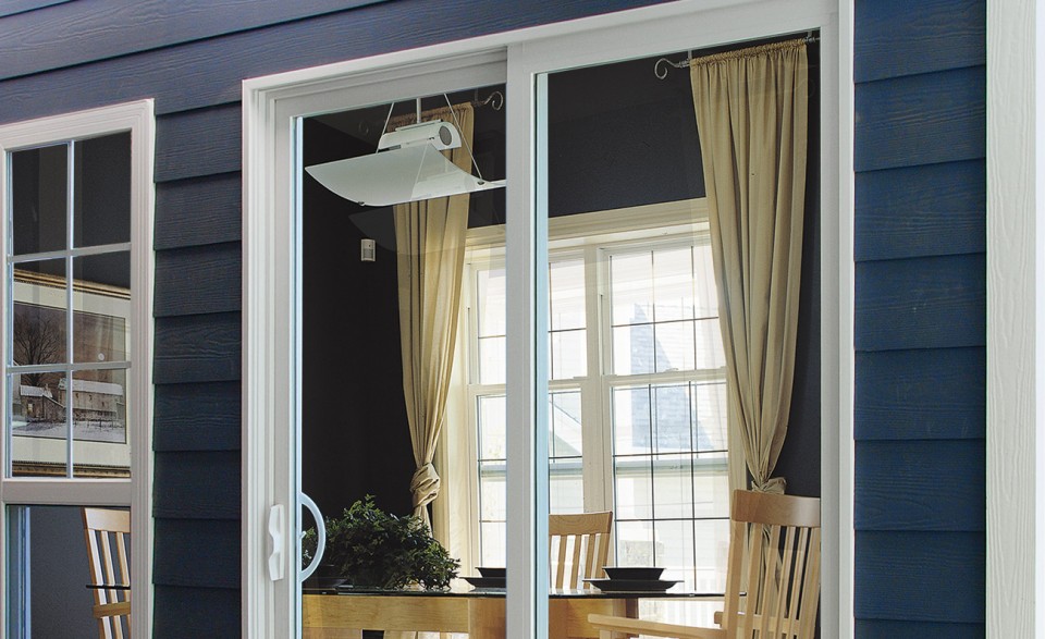 Two wide patio sliding doors off of a home's dining room.