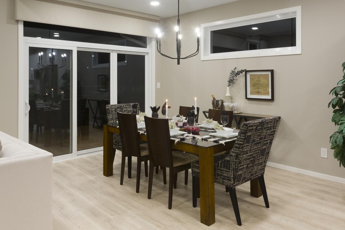 3 wide vantage patio doors off of a modern dining room of a new home